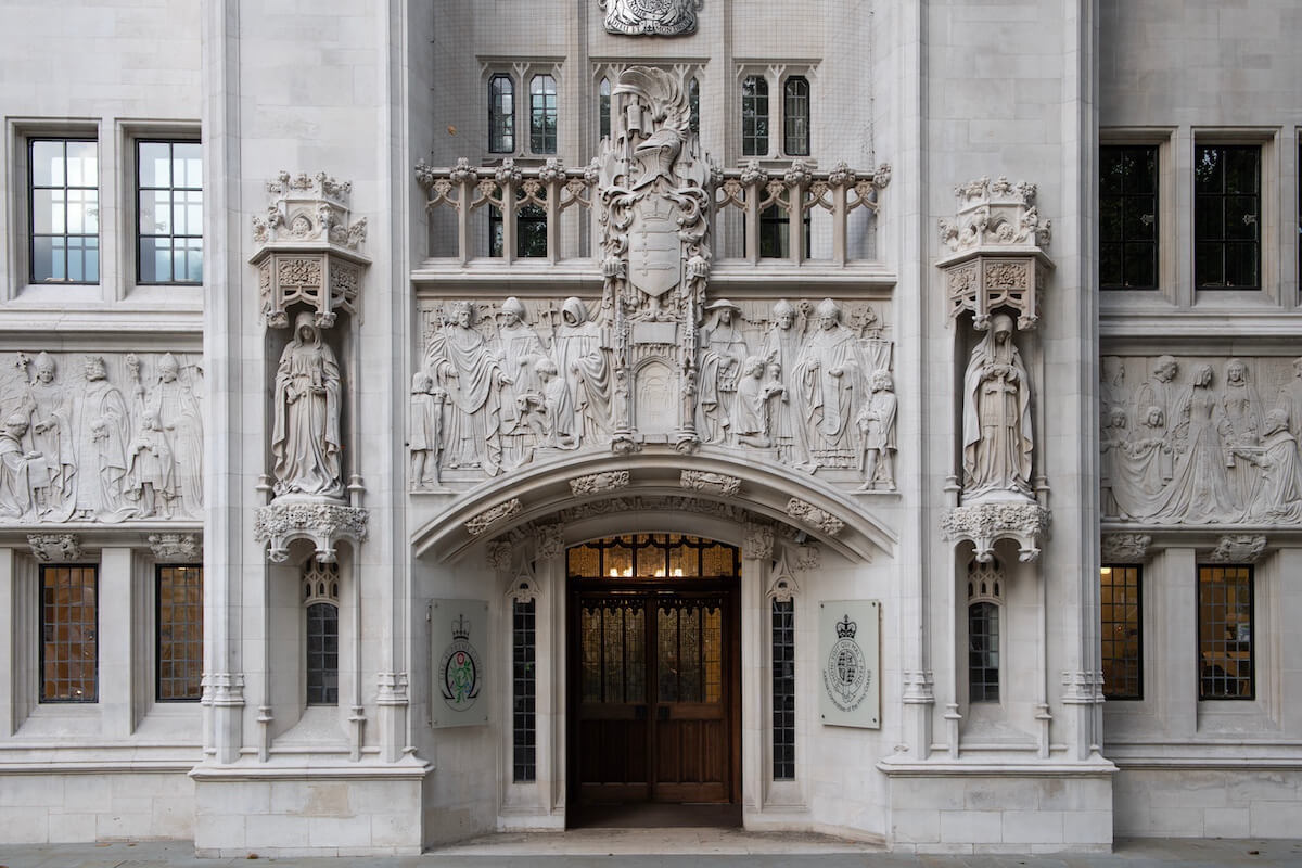 UK Supreme Court in session, symbolizing the legal analysis of asylum policies. Explore the nuanced ruling in [2023] UKSC 42, addressing the pragmatic approach and ethical considerations in offshore asylum processing.